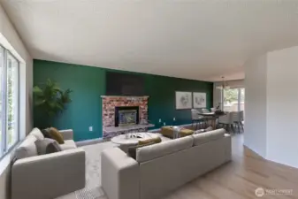 Brick gas fireplace flows into the dining area. Virtually staged.