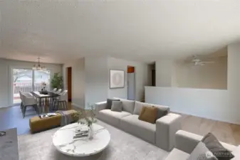 Living area flows into the dining area with a slider out to the deck and backyard. Virtually staged.