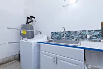 Sink and new H2O heater in garage.