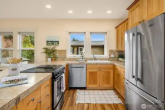 The kitchen is thoughtfully designed with an abundance of storage and ample counter space, offering a perfect blend of functionality and style.