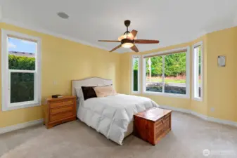 Over-sized primary bedroom is filled with bright natural light.  An abundance of space for a large Bed plus furnishings.