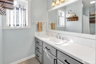 Relax in the primary bath featuring stylish tile flooring and a modern vanity.