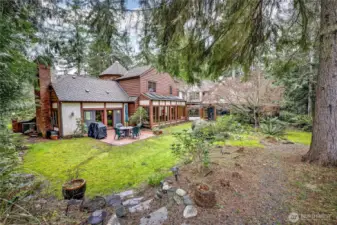 Backyard offers terrace gardens and a brick patio