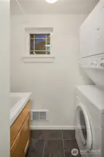 Finished laundry room with sink and tile flooring - freshly painted.