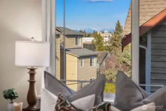 Territorial glimpses with the Cascade Mountains beyond from primary bedroom and loft.