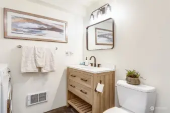 3/4 bath on lower level has brand new vanity & fixtures and also includes a shower and washer/dryer
