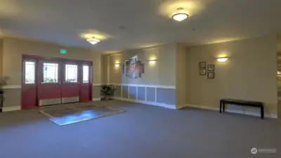 Oversized lobby entrance with new carpet throughout shared spaces and halls