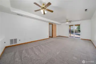 The spacious downstairs family room opens right out to a large backyard—perfect for relaxing or entertaining.