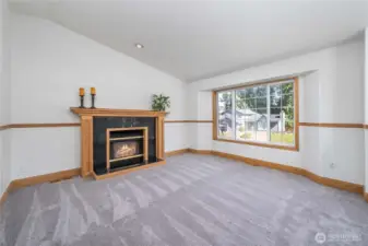 Bright and spacious living area featuring a cozy gas fireplace!