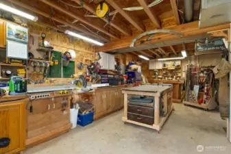 A fun and functional workshop located in the basement, with a door to the living space as well as a door to the exterior of the home.