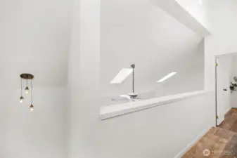 Hallway overlooks the living area below.