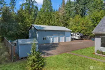 Shop sits to the back of the acre + a garden shed!