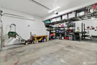 Tandem 3 car garage with over head storage.  2 EV charging stations.