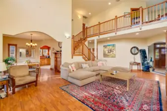 Note the custom arch between the living room, dining room and kitchen!  And the open stairway and open upstairs hallway create light-filled living throughout.