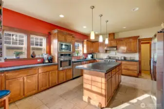Kitchen with solid surface countertops, stainless appliances and lots of natural light! Beautiful and durable travertine flooring.
