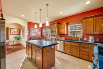 Looking from the kitchen pantry & laundry room into the kitchen.  Notice the built in storage in the kitchen island!