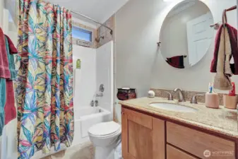 Guest bath with tile accents, custom vanity and upgraded fixtures.