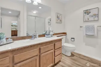 LVP flooring continues into bathroom. New light fixture.