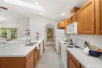 Kitchen with fridge, range, dishwasher microwave, and garbage disposal.