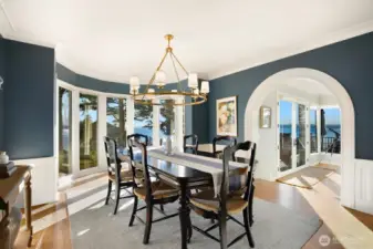 Entertain effortlessly in the formal dining room and spacious living room with gas fireplace and wood-planked top-nail hardwoods. French doors open to a view deck—perfect for sunset dinners—while expansive windows frame breathtaking water and mountain vistas from nearly every room.