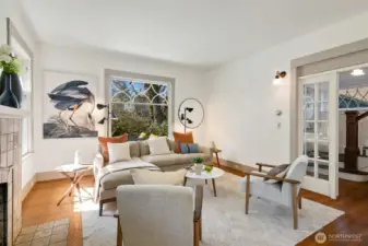 Through French doors, the hallway leads to living room/dining room