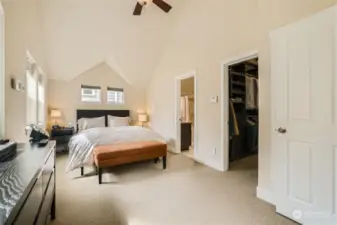 The upper floor hosts the primary bedroom, lovely vaulted ceilings, a walk in closet (on right).