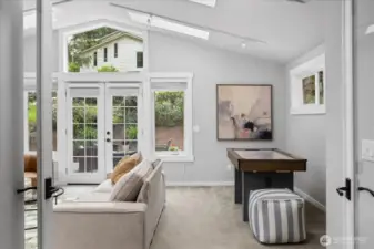 This spacious room has french doors that open to a side yard. This home has so many spaces to not only enjoy the outdoor views, but to also enable bringing the outdoors, in.