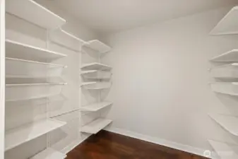 Large walk-in closet with closet system allows for efficient storage opportunities.