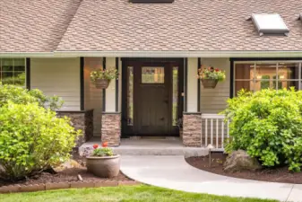 Welcome covered entry with a newer craftsman-style front door.