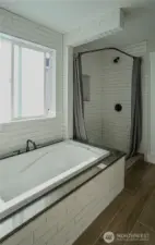 Primary soaking tub and stand up shower