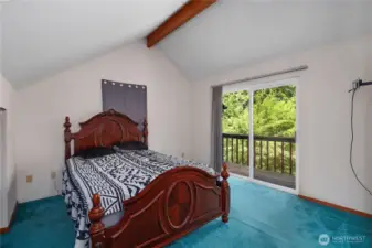 Primary bedroom with your private balcony looking onto the landscape.