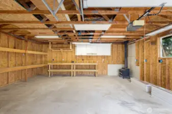 The Ultimate Workshop Setup  Dreaming of a dedicated creative space or workspace? This detached garage features full power, built-in workbenches, cabinetry, and even a wood stove—ideal for year-round projects.