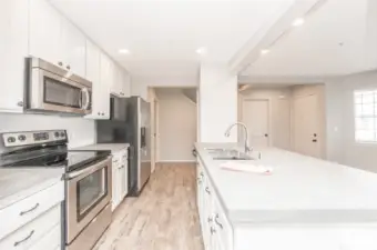 Kitchen with stainless steel appliances and cement finish countertops