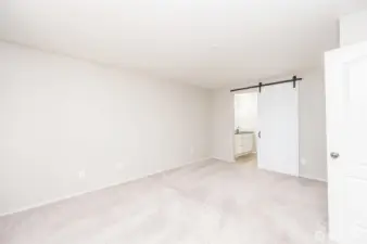 Main primary bedroom facing connecting bathroom