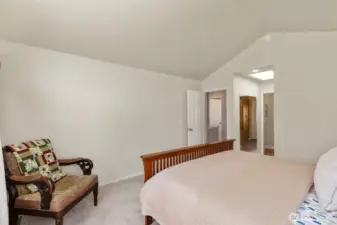 Another shot of the primary bedroom with vaulted ceilings.