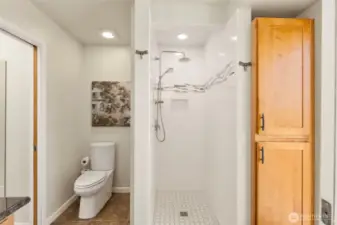 Another shot of primary bathroom with tons of storage and walk in shower.