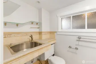 Half bath on lower level has outline of where a shower may have previously existed. Plenty of room to add shower.