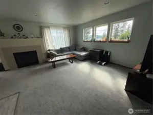 Living room with nice views of Hood Canal and secondary heat via propane fireplace.