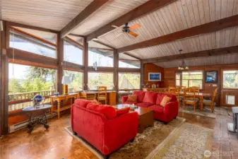 The well appointed living room looks out over the water. Head out onto the deck for an even more spectacular view!