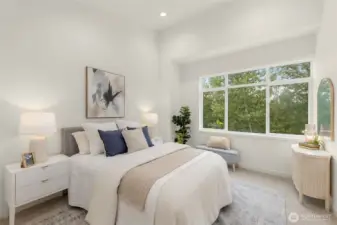 Sun-filled primary suite offers a peaceful retreat with treetop views and space to unwind. (photos of model home)