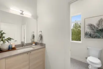 One of the ensuite guest bathrooms featuring contemporary finishes and stylish fixtures. (photos of model home)