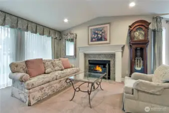 Lovely living room offers cozy fireplace and beautiful mantle. Sliding doors lead to the private back yard.