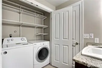 Laundry room is located behind French doors in the main bathroom.