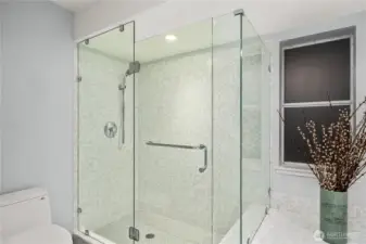 Primary shower with soothing stone floor.