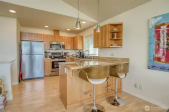 The kitchen has wonderful shaker cabinets and an eating bar.