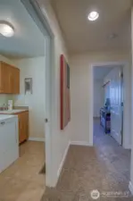 Lower entrance hall to this reverse living home. The laundry is on the left and the first guest bedroom ahead.