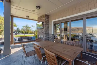 Outdoor fireplace, outdoor TV, outdoor dining table.  We must be in Chelan with its predictably enjoyable outdoor living!