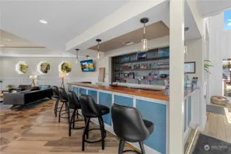 Pass by the wet bar as you enter the main floor lounge. Note the nautical-theme windows.