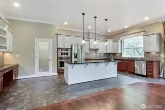 Kitchen view, HUGE island, tile floor, walk-in pantry, matching stainless steel appliances, planning desk to your left, full tile backsplash, all the touches!