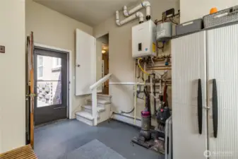 From utility room - stairs up to kitchen, door opens to patio